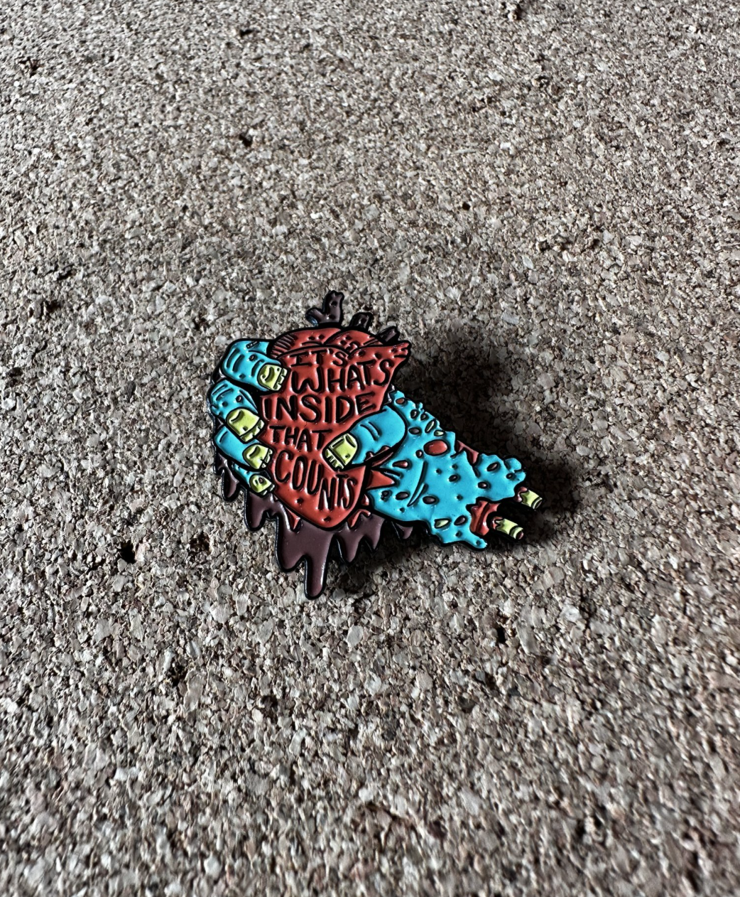 What's Inside That Counts enamel pin
